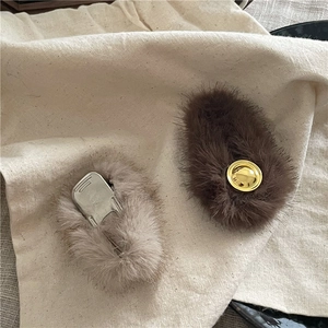 Plush faux fur hair clips in brown and beige with round gold metal accents