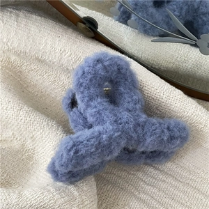 Close-up of soft blue plush hair claw clip with a strong silver metal spring mechanism