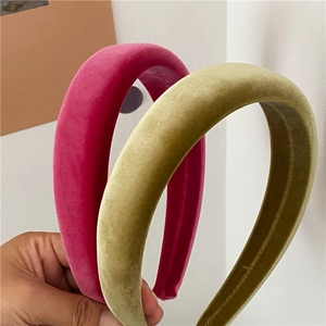 Close-up of thick velvet headbands in rose red and olive green for padded hair style