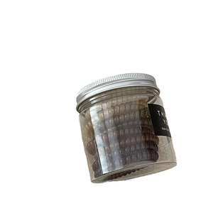 Neutral earth tones spiral hair tie set in a clear plastic jar with metallic lid