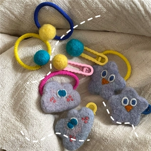Detailed set of handmade star and cloud wool felt hair clips and elastic hair ties