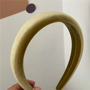 Detailed texture of olive green velvet padded headband with high-top sponge design