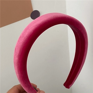 Detail of the thick padded velvet headband in deep pink showing soft texture and volume