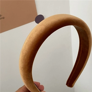 Detailed close-up of thick velvet headband showing soft yellow fabric texture and sheen