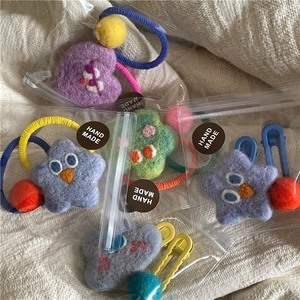 Handmade wool felt hair clip set featuring cartoon star and heart designs in a gift pouch
