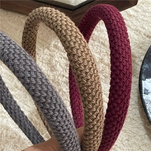 Detailed close-up showing thick knitted textures of gray, khaki and burgundy headbands