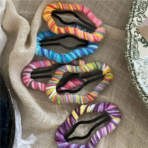 Set of five colorful wool knitted cloud BB hair clips with vibrant rainbow patterns