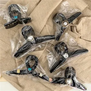 Set of six fashion plush claw clips with pearls and rhinestones in clear packaging