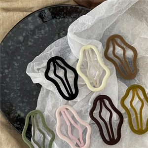 Detail view of wavy velvet hair clips in seven elegant Morandi colors on soft background