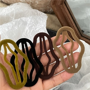 Set of four flocking cloud BB hair clips in green black and brown wavy geometric designs