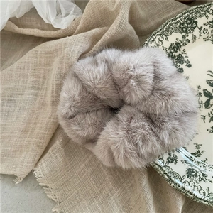 Luxurious faux mink fur hair scrunchie in grey-purple, fluffy winter ponytail holder closeup