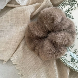 Detail of soft mocha brown faux mink fur scrunchie with plush texture and elastic hair tie