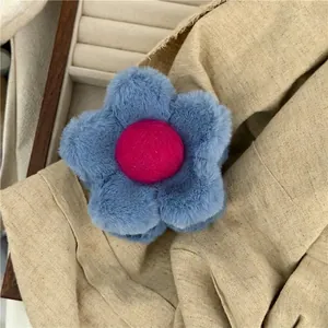 Fashionable plush flower hair clip in deep blue with a soft fuzzy velvet finish