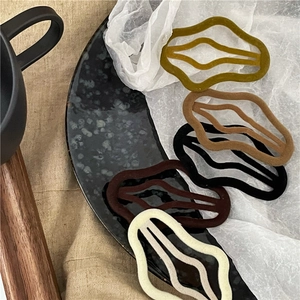 Five-piece set of flocked cloud hair clips in deep winter tones on marble tray