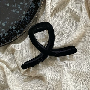 Detail of the soft black flocked texture on the geometric wavy hair claw clip surface