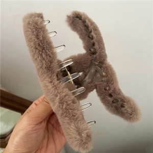 Detail of plush faux fur large hair claw clip in coffee brown with wavy geometric design