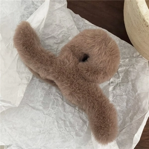 Macro detail of plush coffee brown hair claw clip with faux rabbit fur for elegant styling