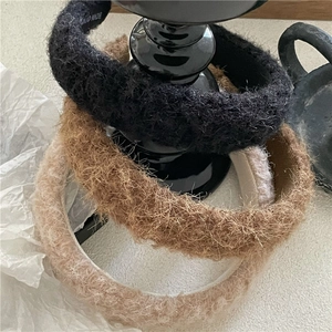 Detailed view of handmade plush wide headbands in black, brown and beige fleece texture