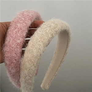 Detailed view of plush pink and beige headbands with non-slip tooth comb design