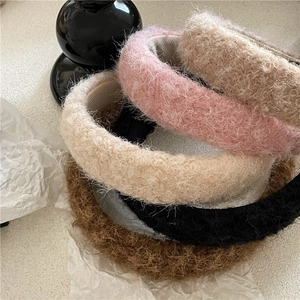 Thick colorful plush headbands in pink, beige, black, and brown for winter styling