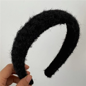 Detailed texture of a wide black fuzzy faux mohair headband for winter styling