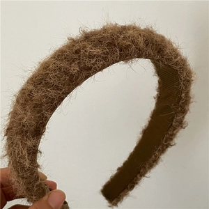 Close-up of soft brown plush wide headband with premium fabric edge for comfort
