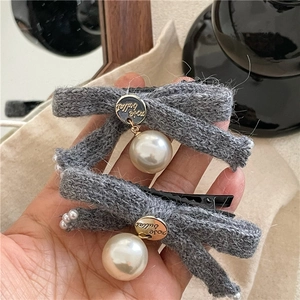 Pair of gray knitted bow hair clips with white pearls and round metal pendants