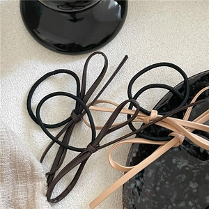 Minimalist PU leather bow hair ties in brown and beige tones for elegant ponytail styling