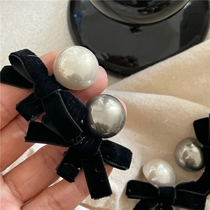 Elegant black velvet bow hair clip set with large faux pearls in white and grey colors