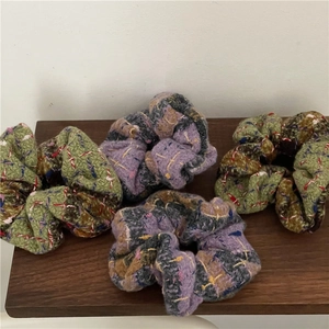 Chunky plaid pattern scrunchies in green and purple knit fabric for winter hair styling