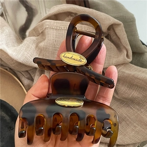 Retro leopard print hair claw clips in tortoise shell resin with gold handmade metal plaque