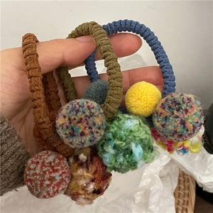 Colorful knitted hair ties set with vibrant plush pompom balls for girls' ponytails