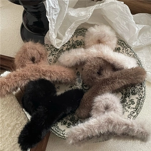 Plush faux fur claw clips in caramel brown, latte, black, and cream white for winter hair
