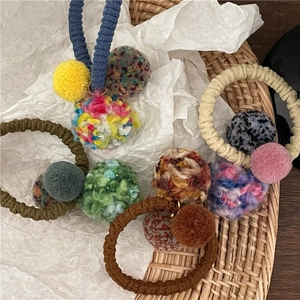 Set of four colorful plush ball hair ties with textured pom-poms for girls