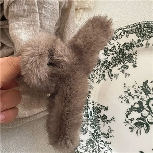 Detail shot of a plush faux mink fur hair claw clip in coffee brown for autumn winter