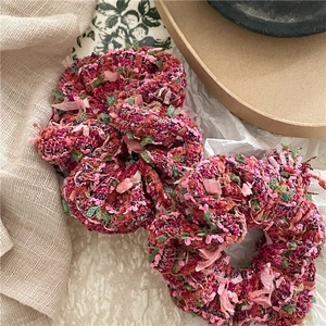 Set of two rose red woolen pleated scrunchies with vibrant textured weaving for women