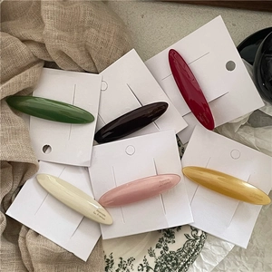 Set of six colorful acetate oval hair clips with glossy finish and Barrette La France text