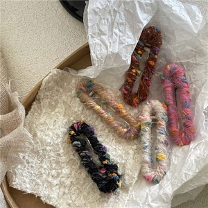 Détail de 5 barrettes ovales en laine colorée dans une boîte cadeau avec dentelle