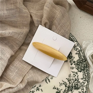 Detail showing amber acetate leaf hair clip with Barrette France text on white card