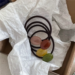 Detail of high-elasticity hair ties with colorful oval resin beads in a gift box