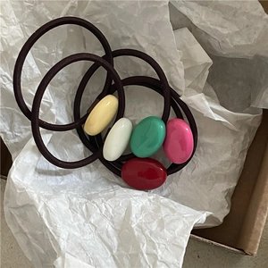 Detail of colorful resin oval beads on high-elasticity hair ties in a gift box