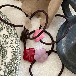 Five assorted colors of floral acetate hair ties with French style engraving in a vintage setting