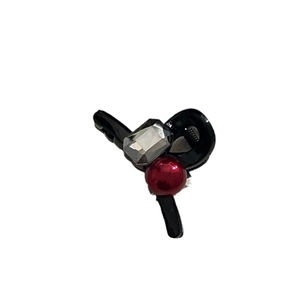 Mini black hair claw clip featuring a translucent grey rhinestone and a red bead accent
