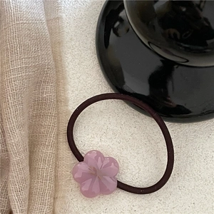 Detailed view of a purple acetate five-petal flower hair tie with high-elastic rope