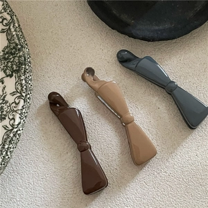 Minimalist Morandi color bow banana hair clips set on a clean aesthetic background