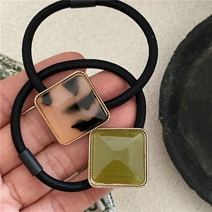 Elegant tortoiseshell and olive green acetate square buckle hair ties on flexible black bands