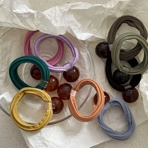 Morandi color elastic hair ties with dark amber beads in minimalist cream style