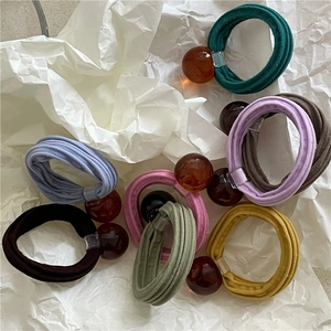 Set of pastel colored elastic hair ties with amber translucent geometric beads