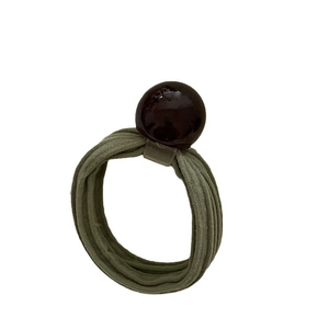 Olive green elastic hair tie with a glossy burgundy round bead decoration on white backdrop