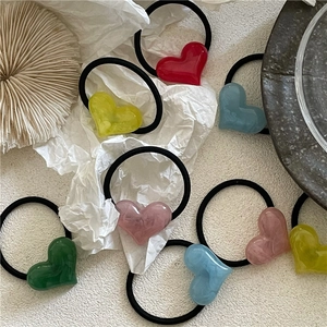 Set of colorful resin heart hair ties with elastic black ropes in various macaron colors